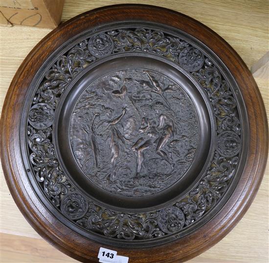 An early 20th century bronzed metal plaque, in oak frame diameter 53cm
